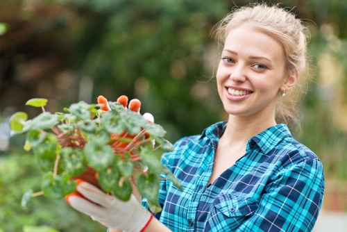 Gardener working in a Vauxhall garden with tools and greenery